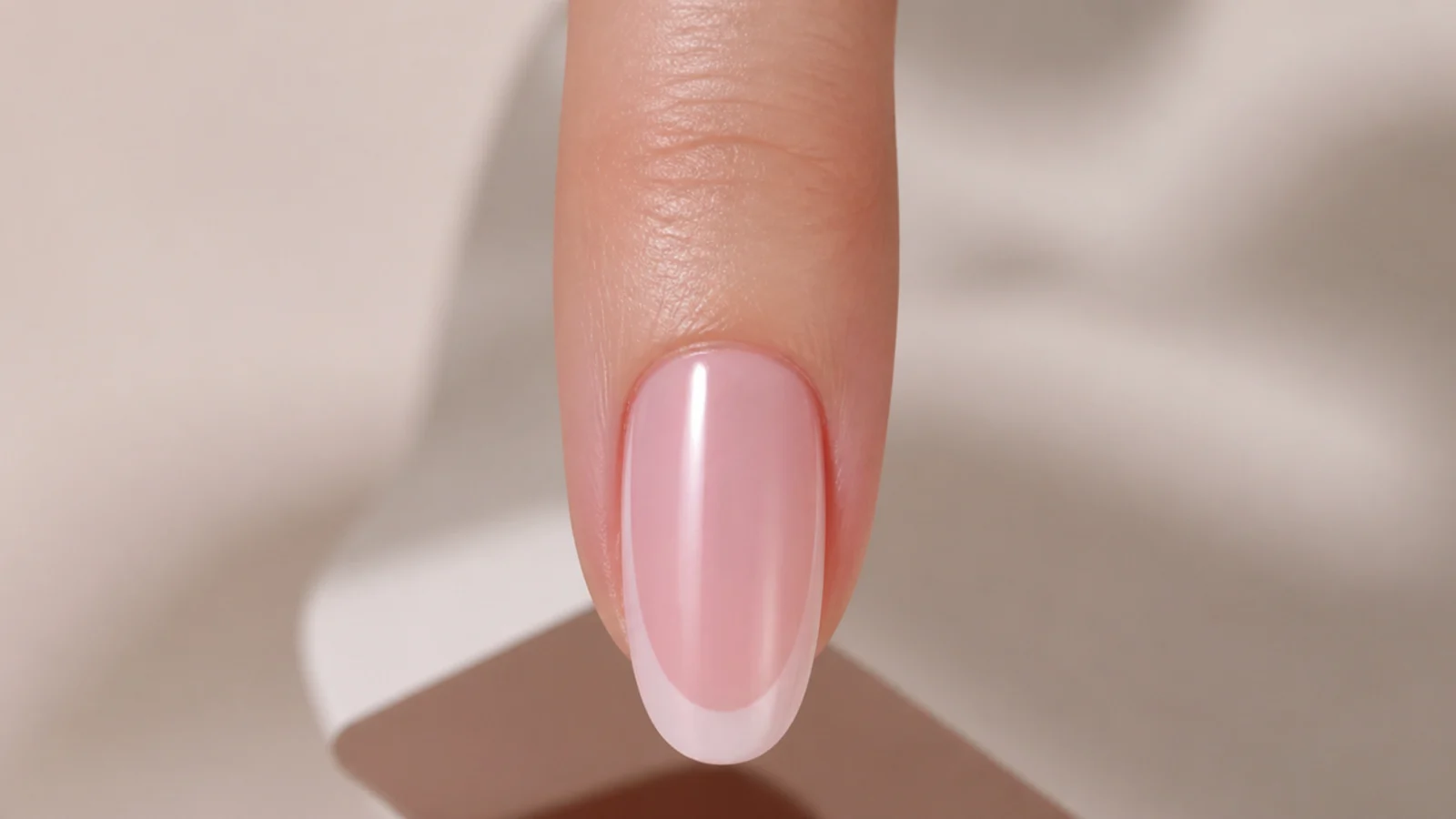 A nail viewed head on down the fingertip showing two matched sidewall tapers before the tip is finished