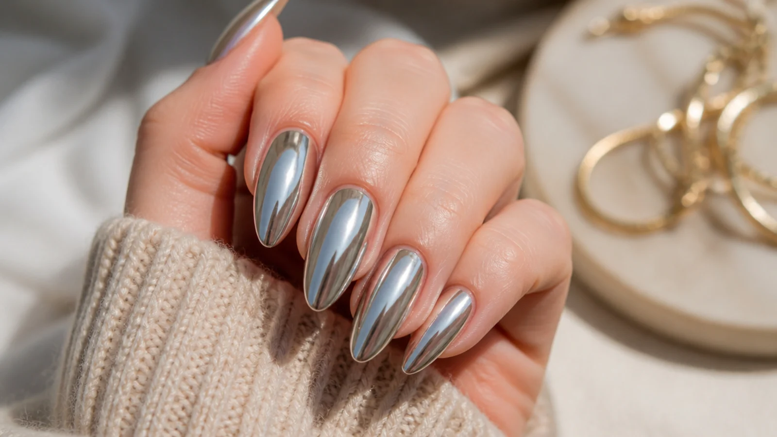 Long almond nails in liquid silver chrome with a mirrored tapered point
