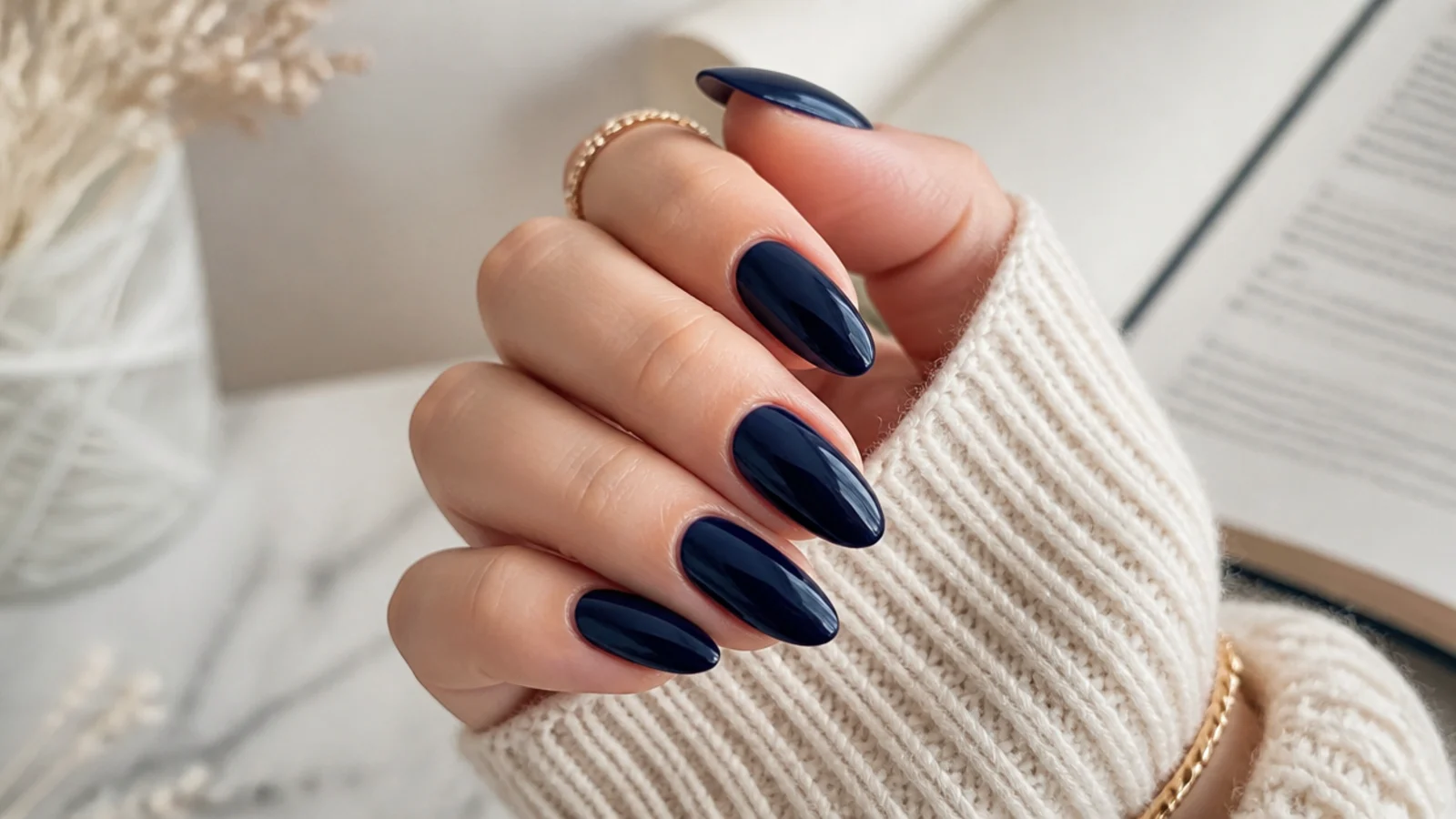Long almond nails in near-black midnight navy with a deep glossy finish