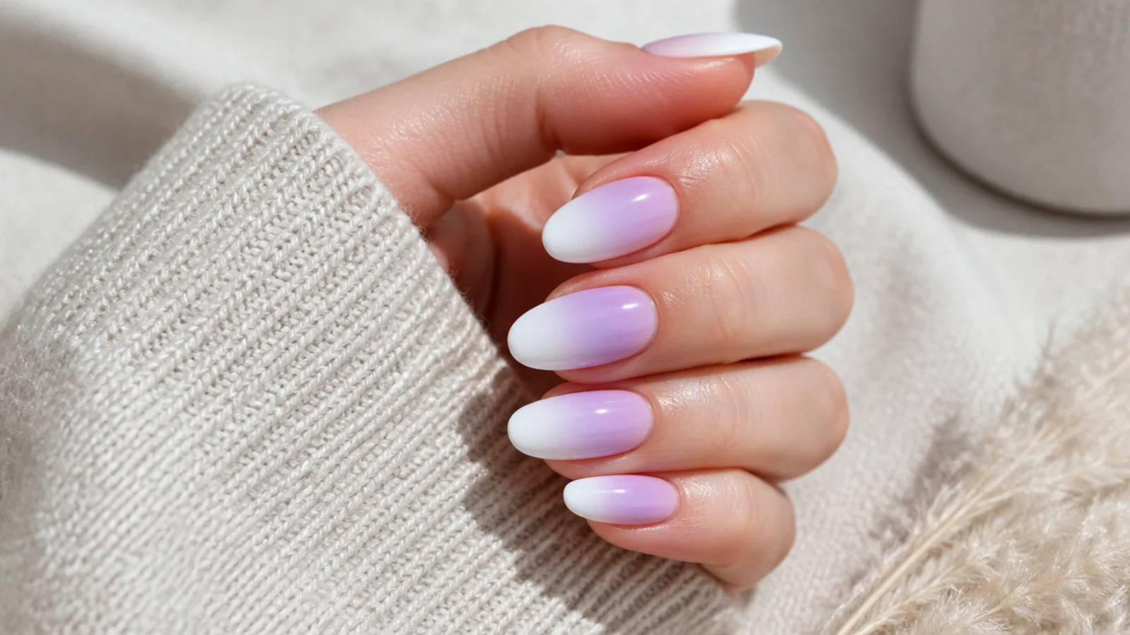 Long oval nails with a lilac to white ombre fading from the cuticle toward the curved tip