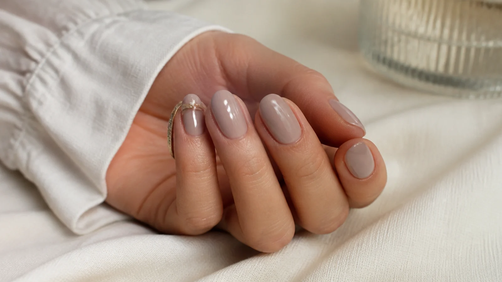 Oval nails in pink greige, a warm gray beige with a pink cast, in a soft cream finish