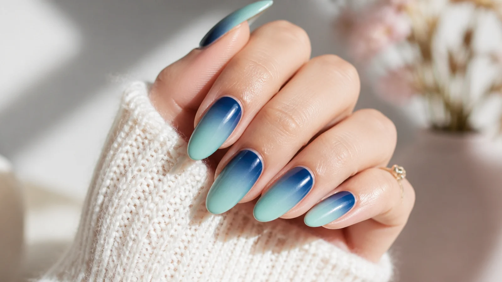 Almond nails with a blended blue gradient from deep navy at the base to seafoam at the tip