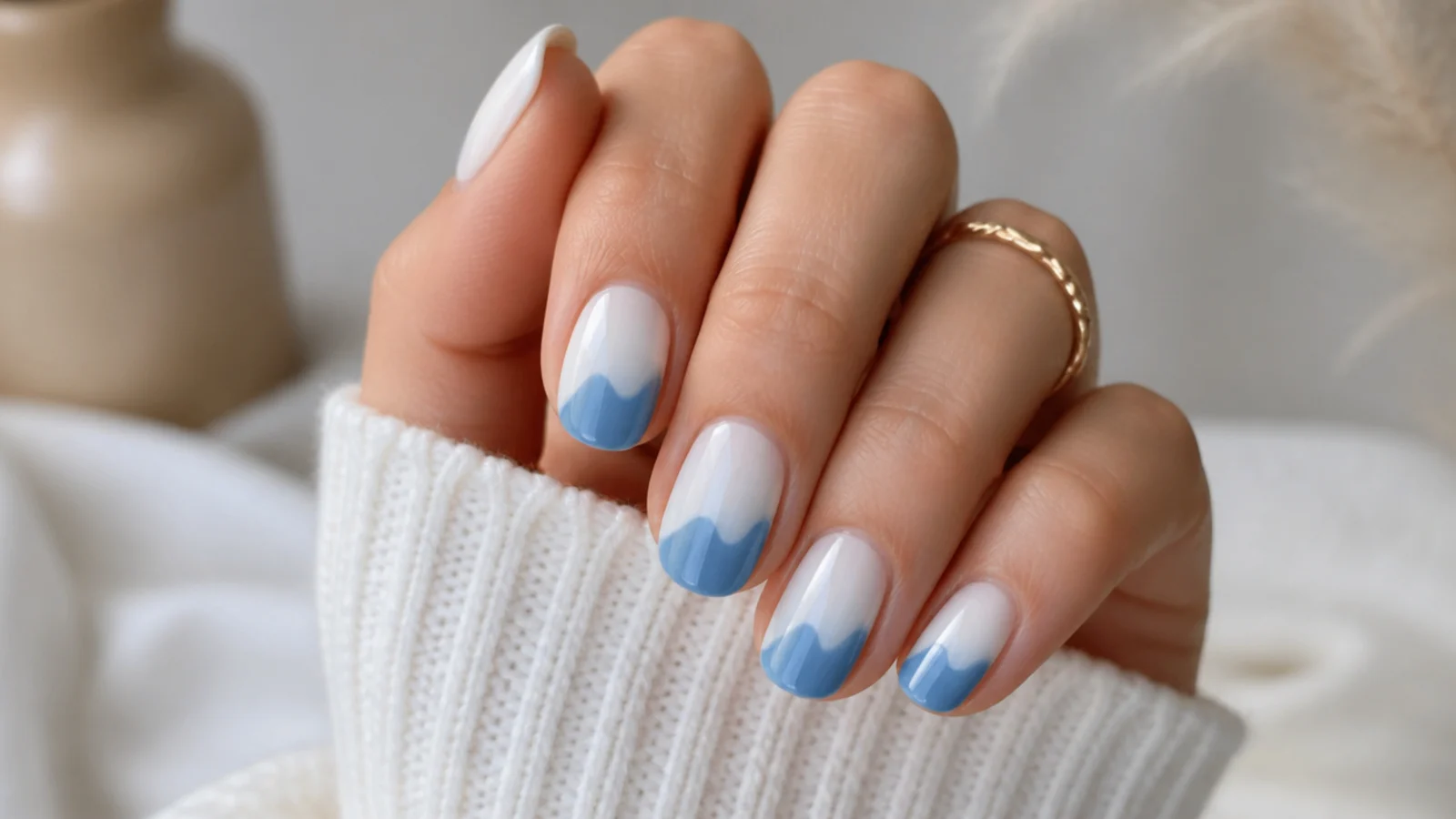Medium nails with a rolling wave-shaped ombre where blue swells up into a white sky on each nail