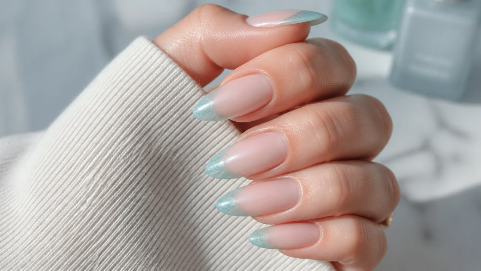 Almond nails with frosted aqua sea glass French tips over a sheer natural base