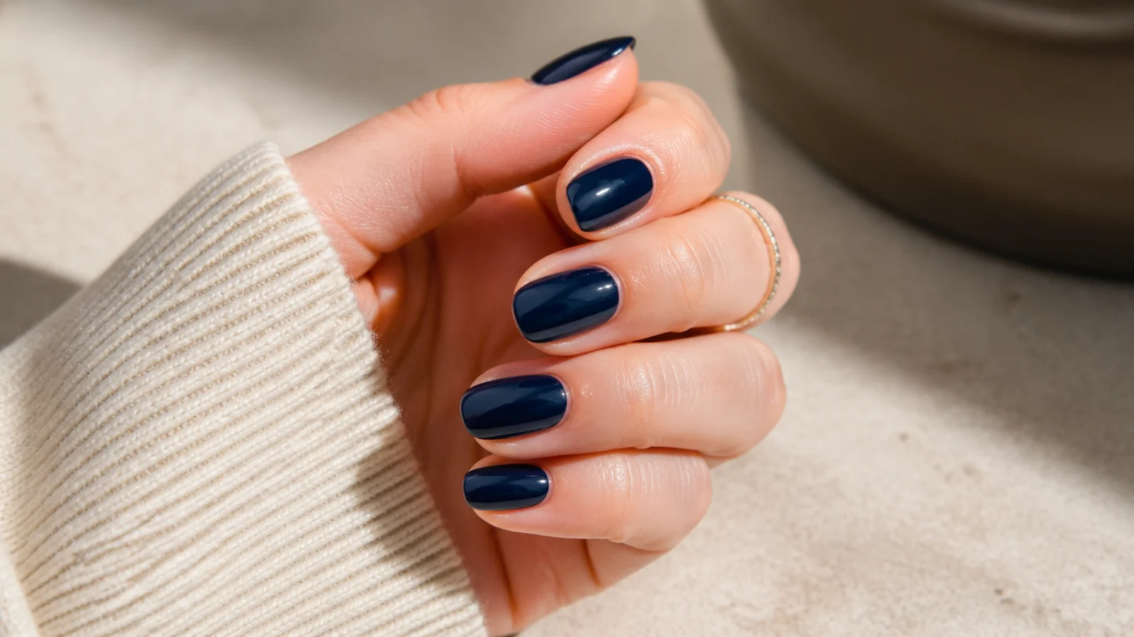 Medium deep navy blue nails in a high gloss single tone with a clean rounded tip