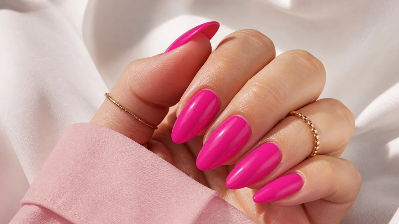 Long almond hot pink summer nails in a glossy blue-based magenta