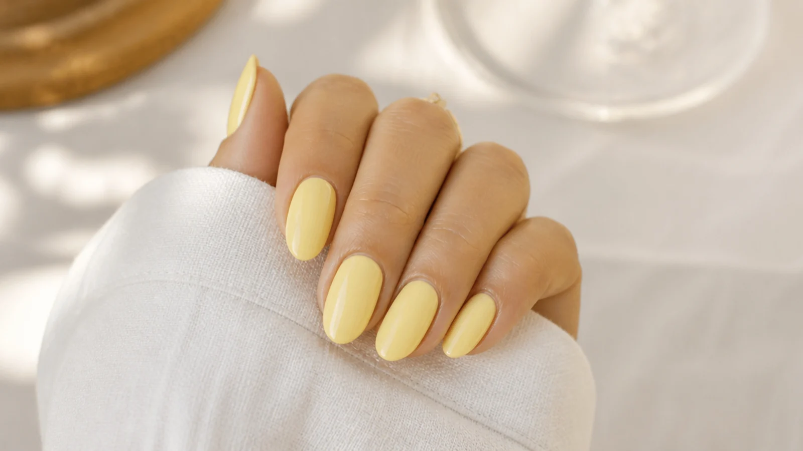Medium almond butter yellow summer nails in a soft creamy pastel