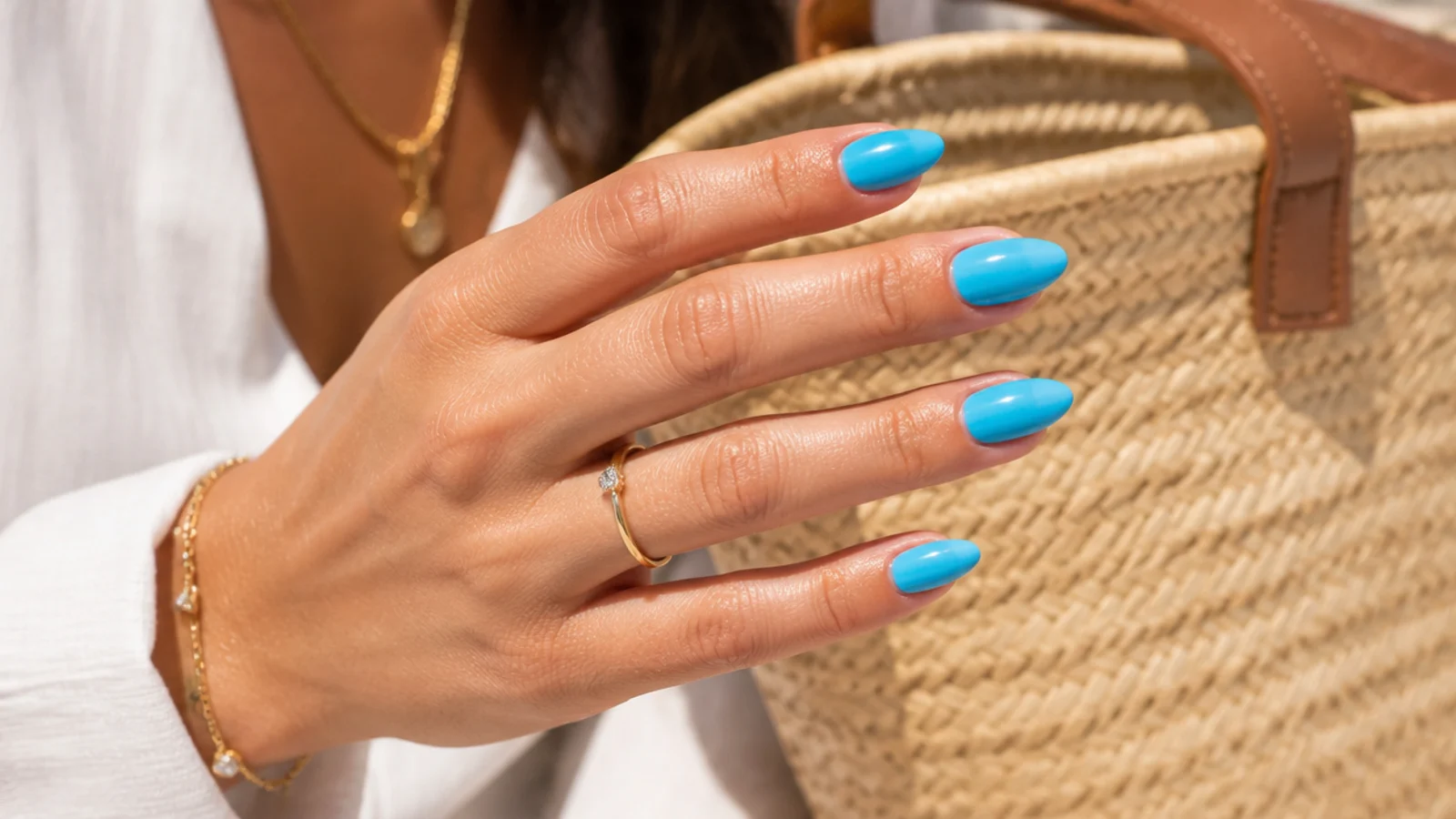 Medium almond Capri blue summer nails in a bright turquoise-leaning blue