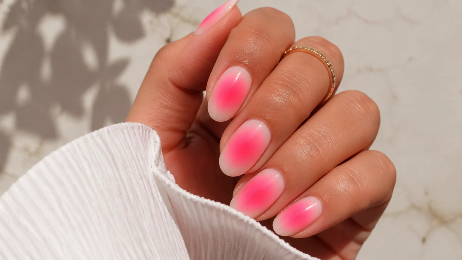 Short almond bright aura summer nails with a neon pink halo airbrushed on a pale base