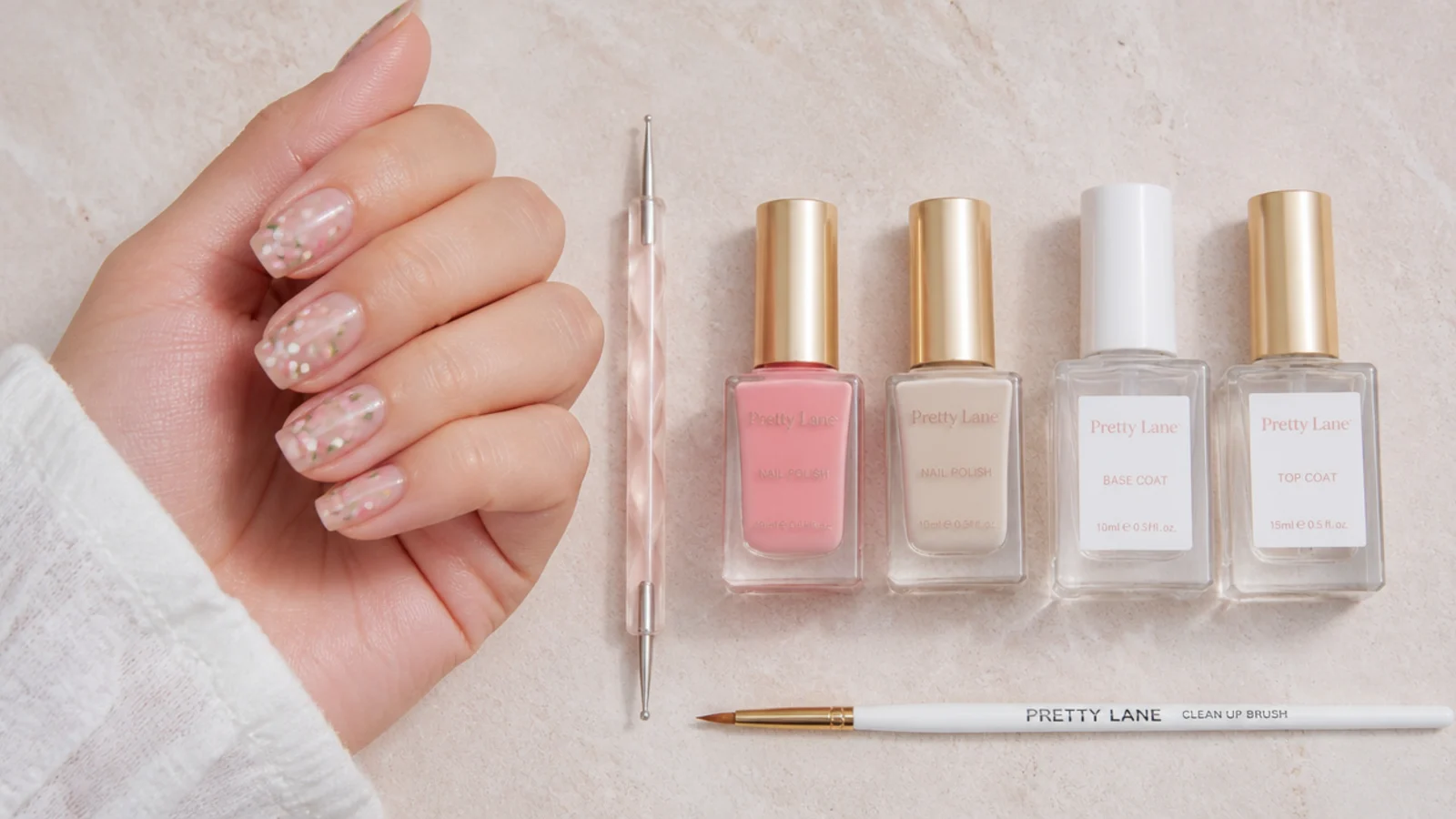 Flat lay of a double-ended dotting tool, two polish bottles, base coat, top coat and a cleanup brush