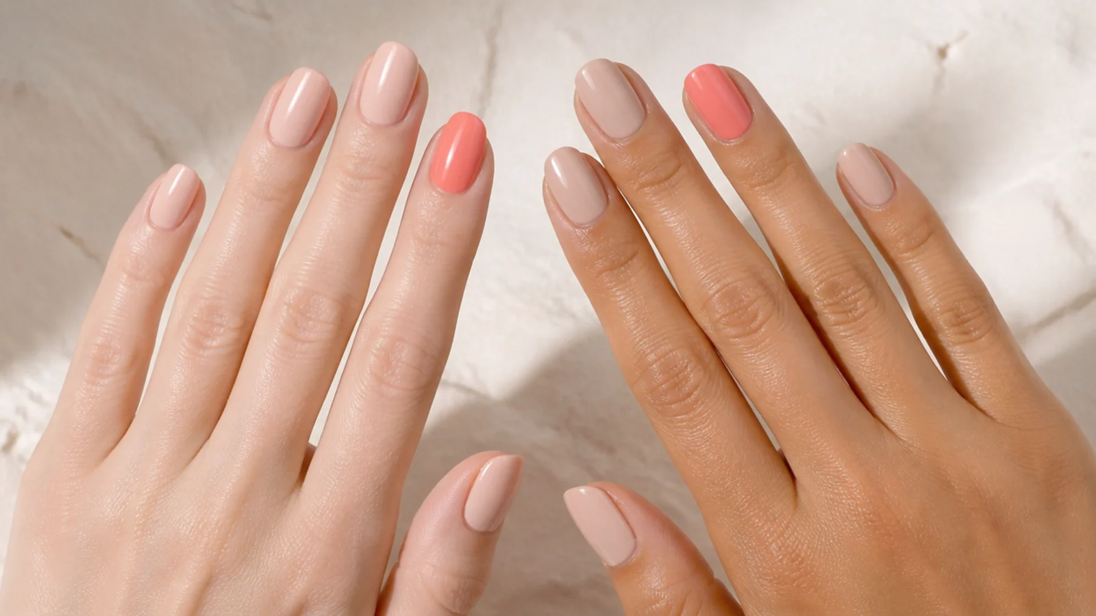 Two hands compared, one pale and one tanned, wearing the same nude and coral polish