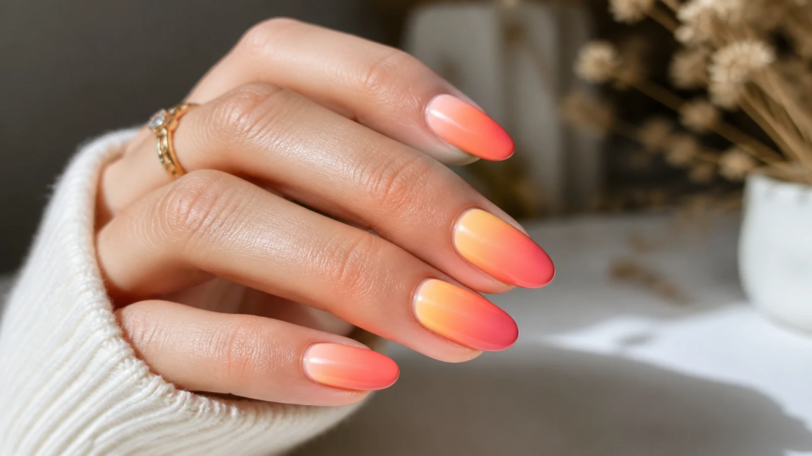 Sunset ombre gel nails fading from yellow to coral to hot pink up the nail