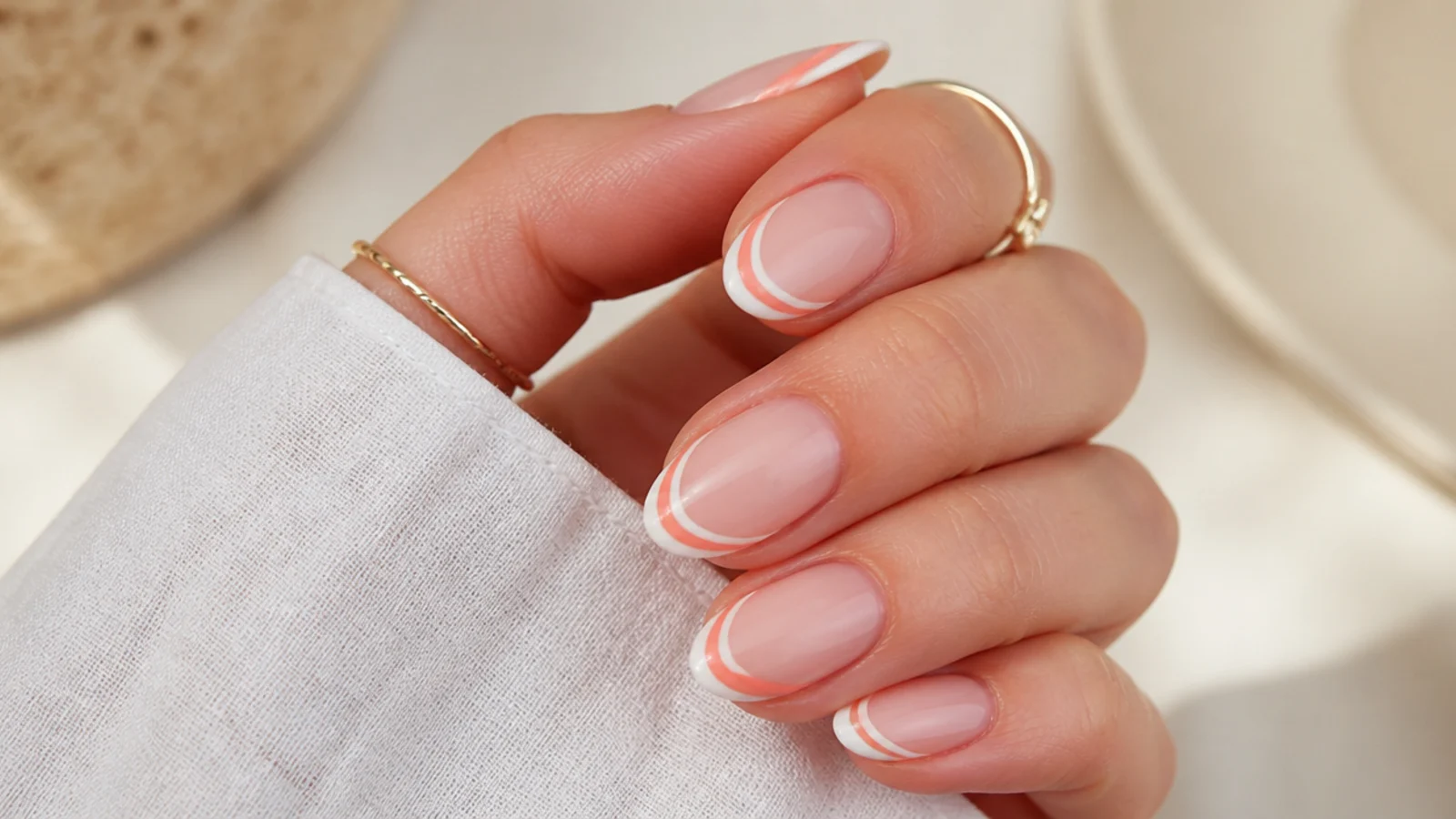Double French tip vacation nails with a white line and a thin coral line on a nude base