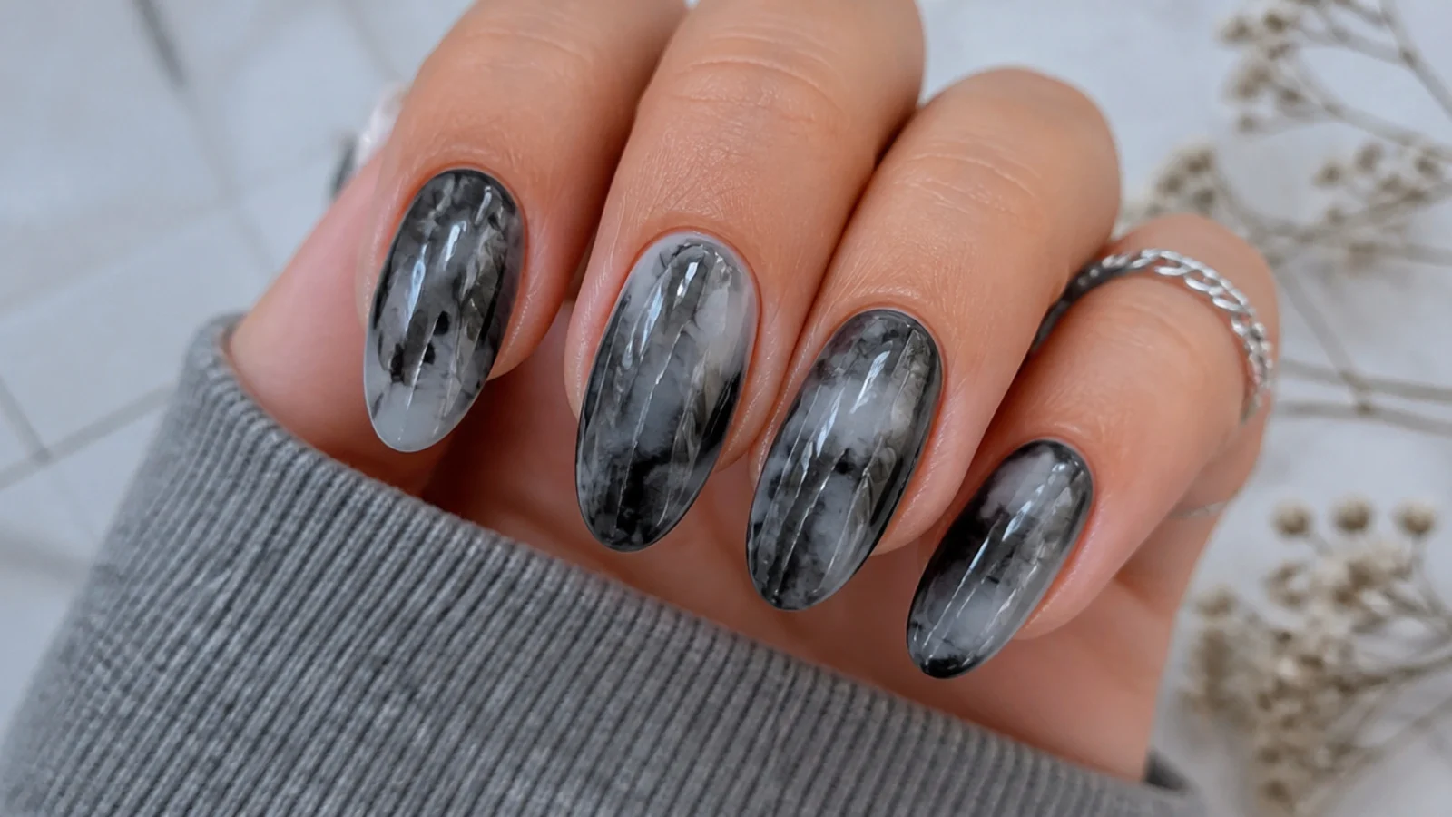 Black and gray tie-dye blooming gel nails with swirled diffusion