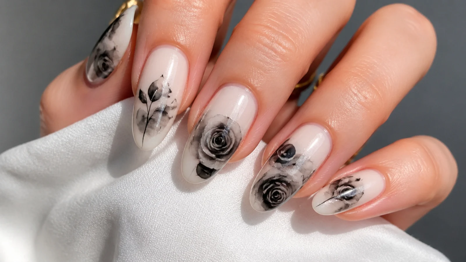 Black watercolor rose blooming gel nails on a pale base
