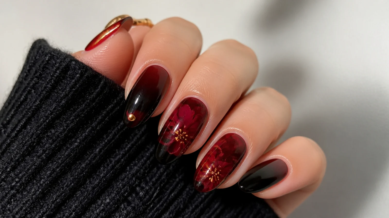 Deep black and red blooming gel nails with cherry-toned diffusion