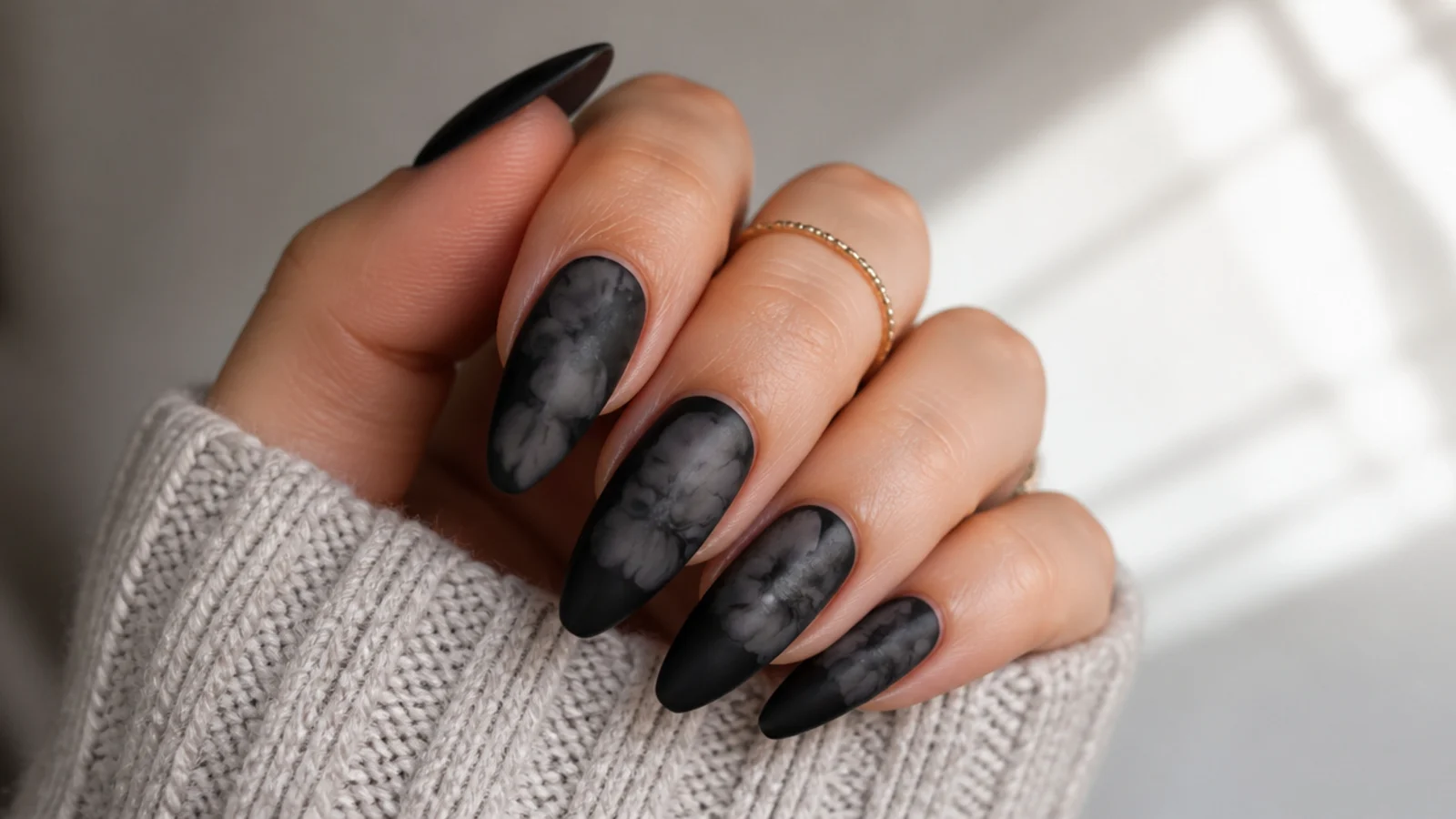 Matte black blooming gel nails with a soft velvety diffused finish