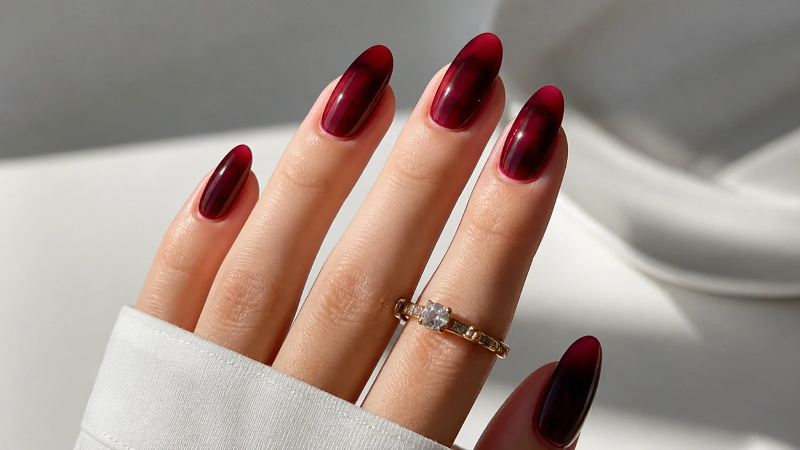 Deep wine-red blooming gel nails with diffused darker cores