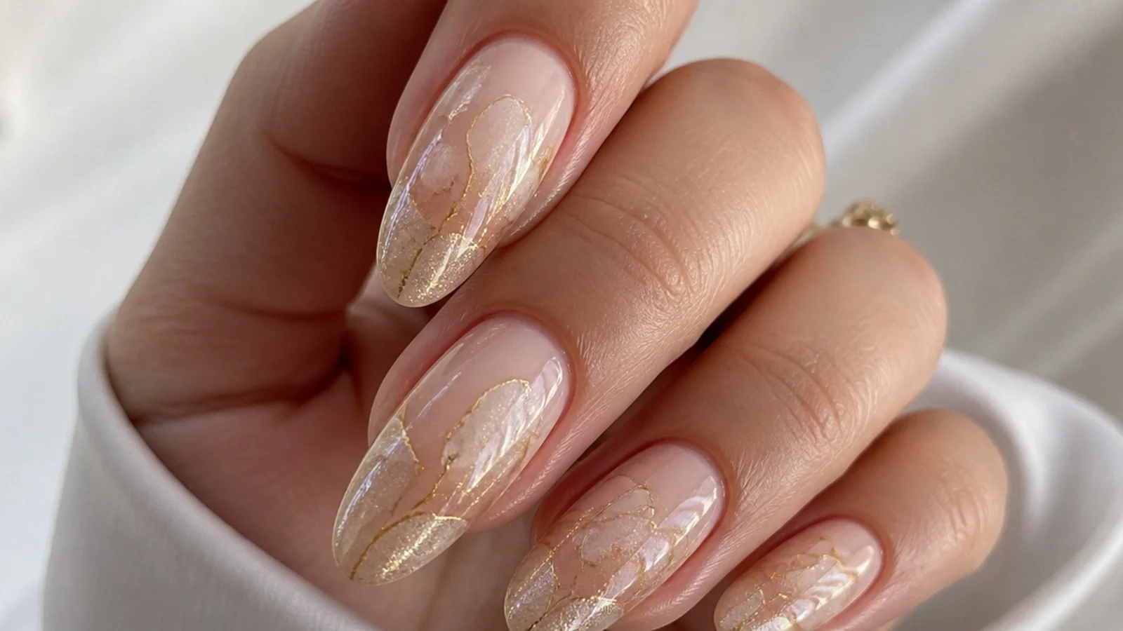 Soft champagne and gold shimmer blooming gel nails