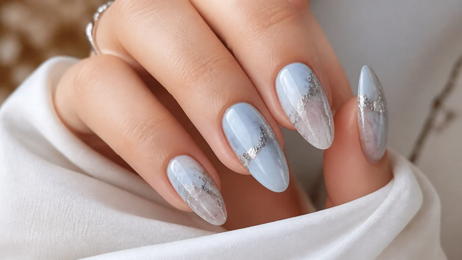 Pale icy blue and silver marble blooming gel nails