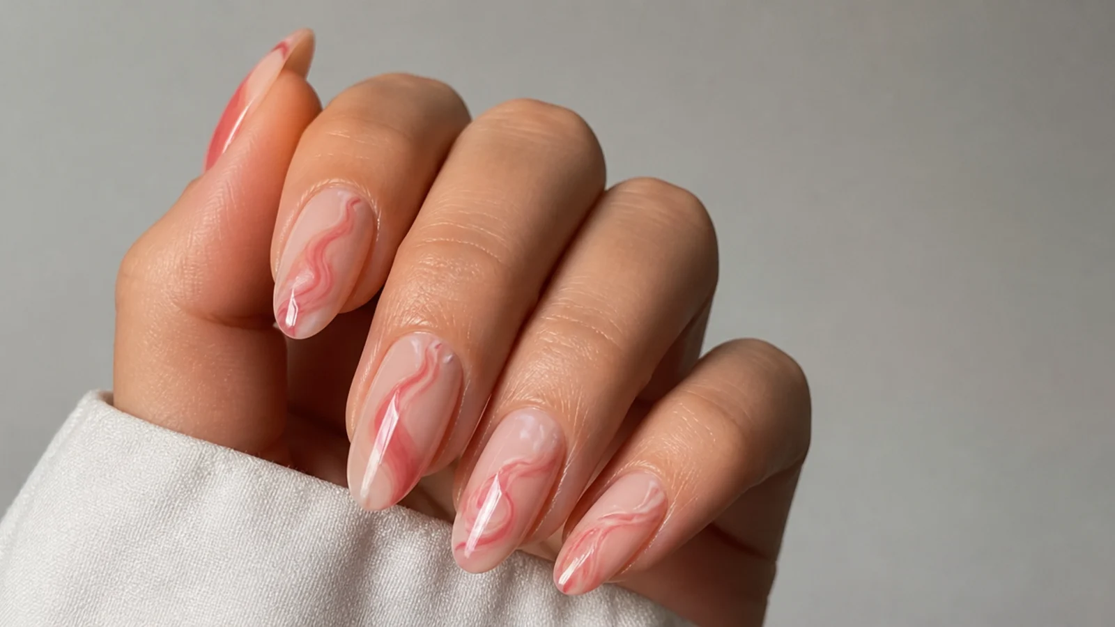 Abstract pink rose swirl marbled into a nude blooming gel nail