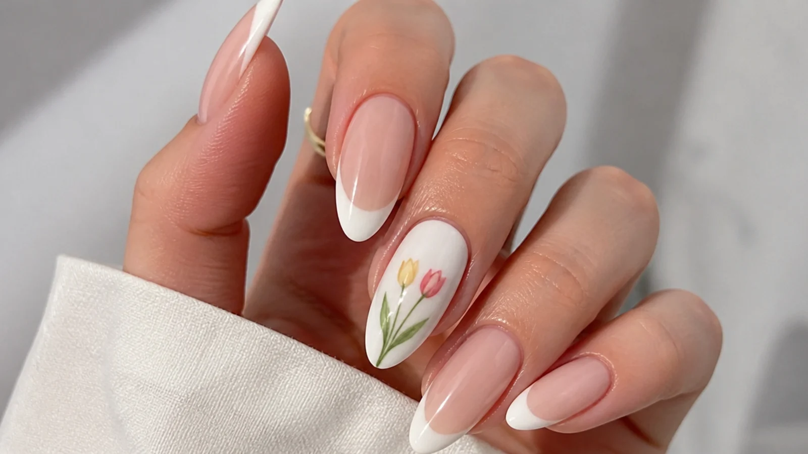 Diffused pink and yellow tulips rising up a white nail