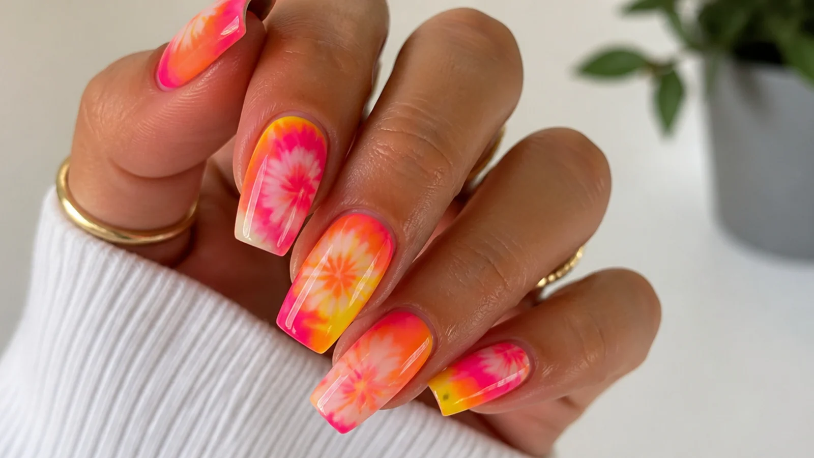 Bright pink, orange and yellow neon tie-dye blooming gel nails