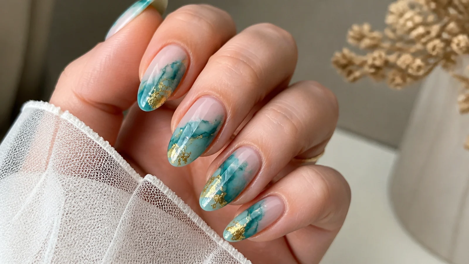 Teal blooming gel nails with gold foil abstract accents