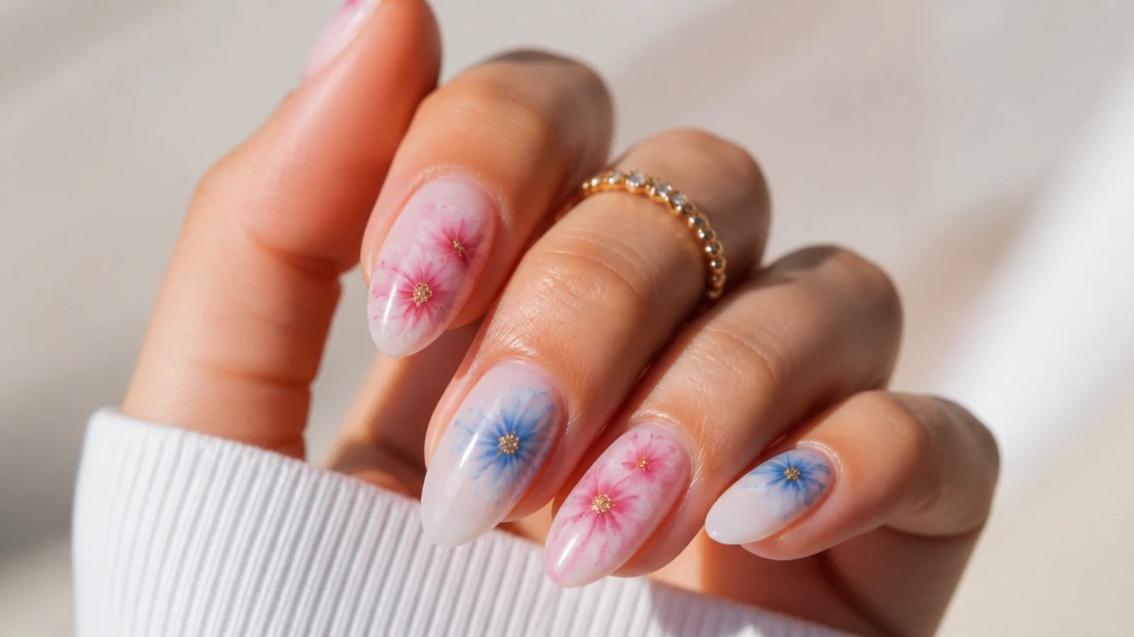 Soft watercolor blooming gel flower nails in pink and blue on almond nails