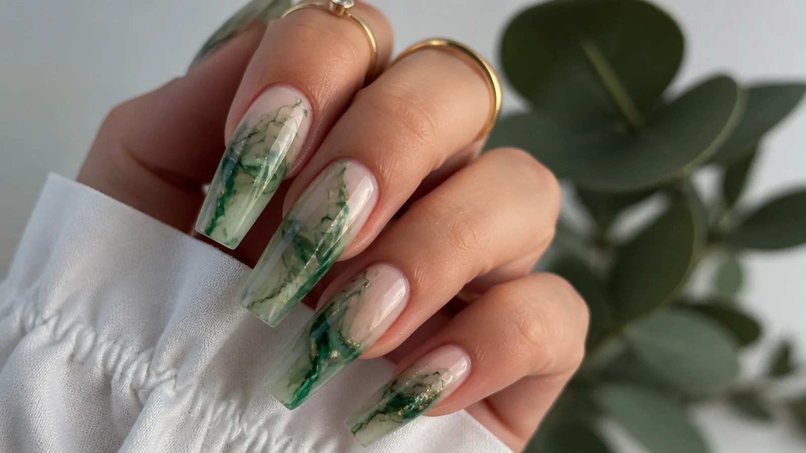 Coffin nails with emerald and jade green ink swirls in blooming gel