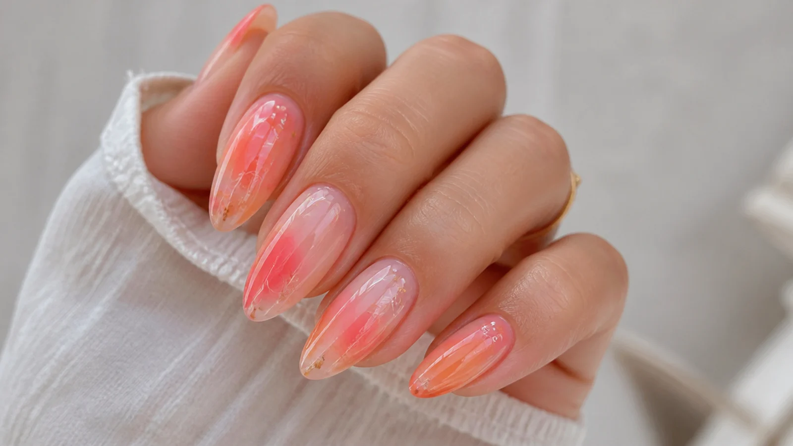 Almond nails with coral, peach and pink blooming gel blending like a sunset