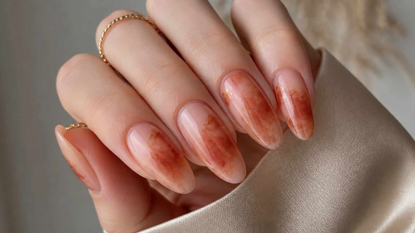 Almond nails with terracotta and rust blooming gel diffused over nude
