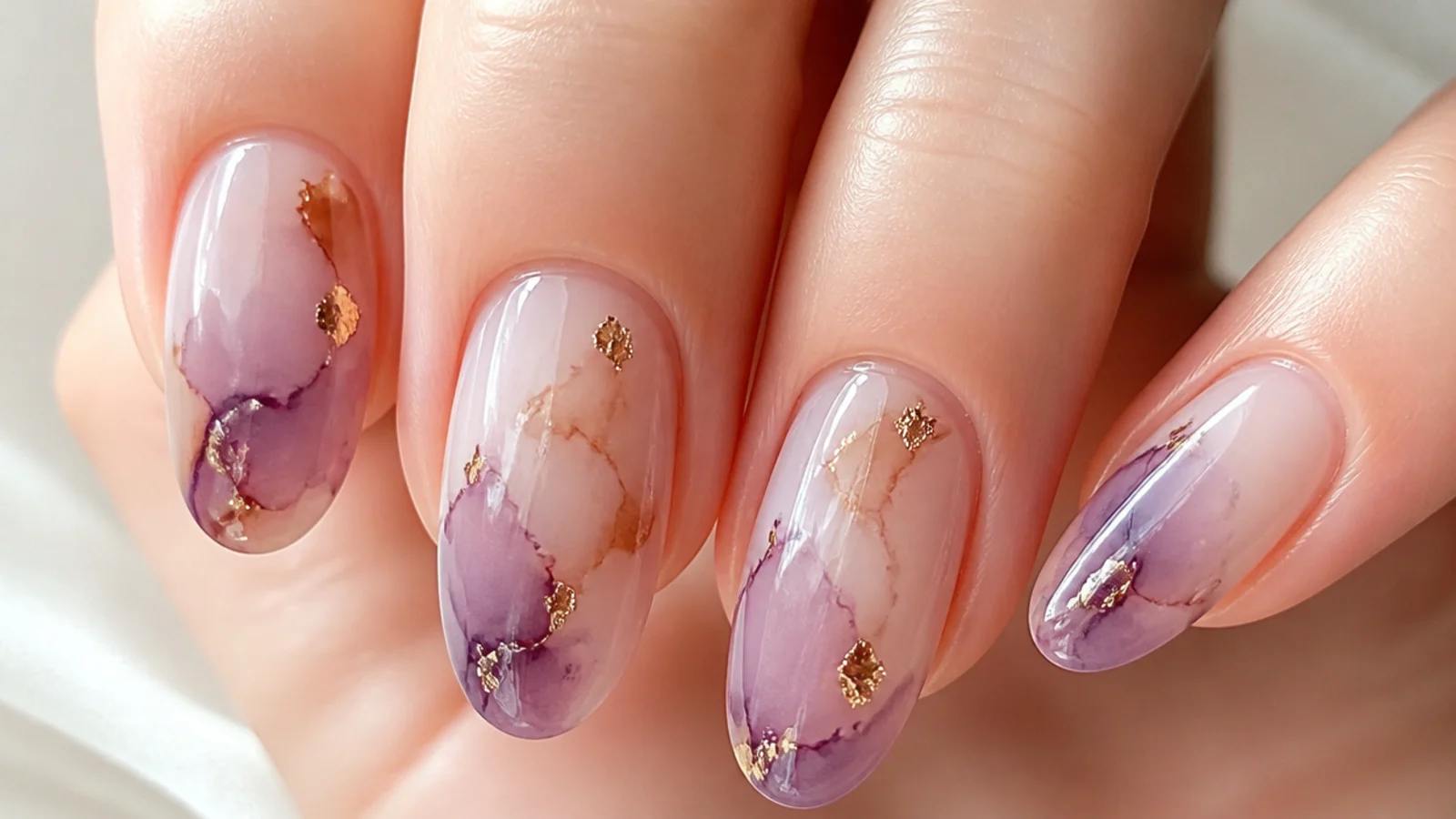 Close-up of gel color diffusing across a nail through clear blooming gel