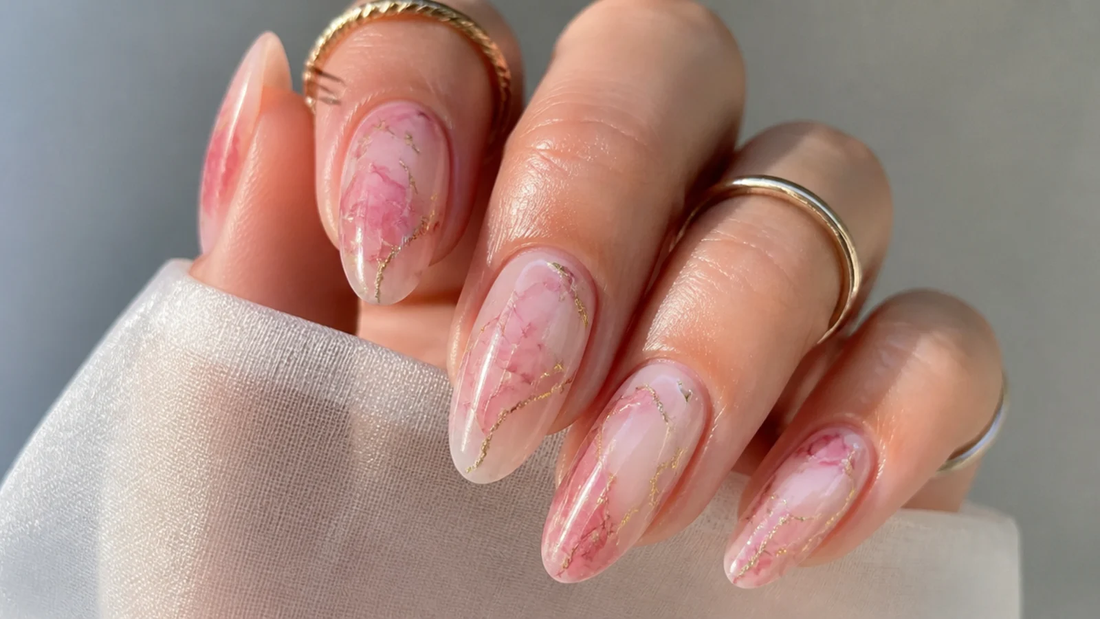 Blush marble blooming gel nails with thin gold foil veins
