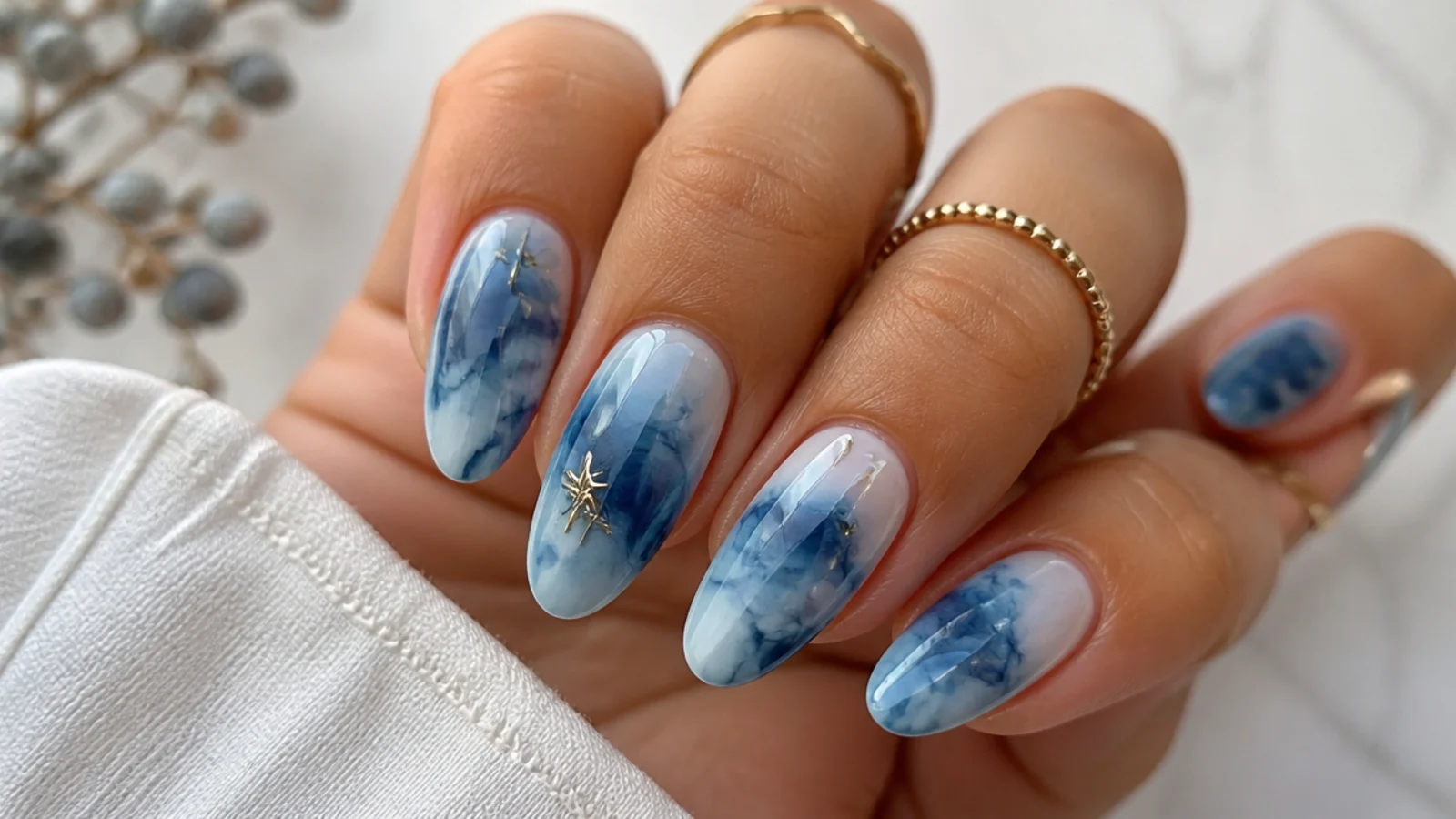 Inky blue and white tie-dye blooming gel nails with diffused swirls