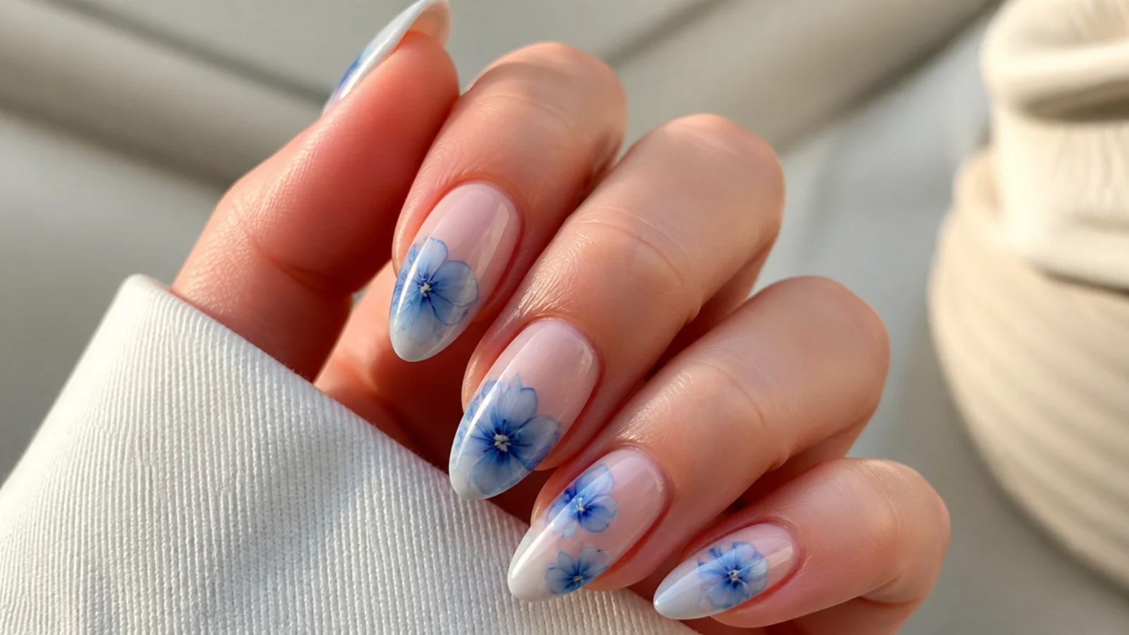 Blue blooming gel nails with soft cornflower blue watercolor flowers