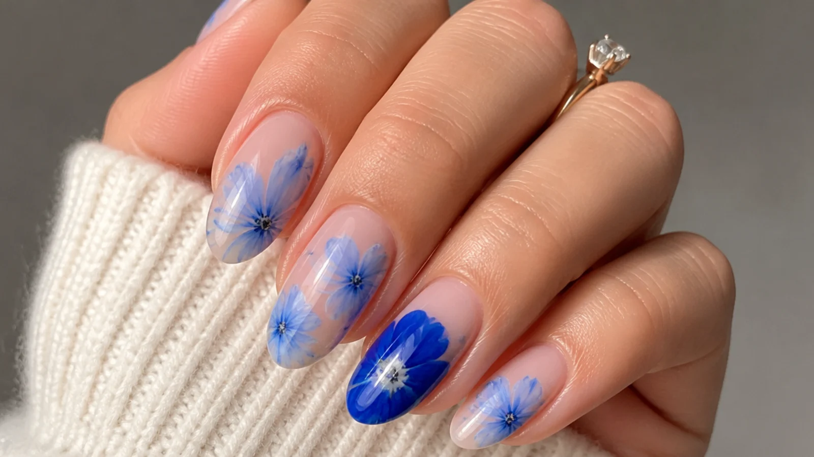 Blue blooming gel nails with one bright cobalt bloom accent nail
