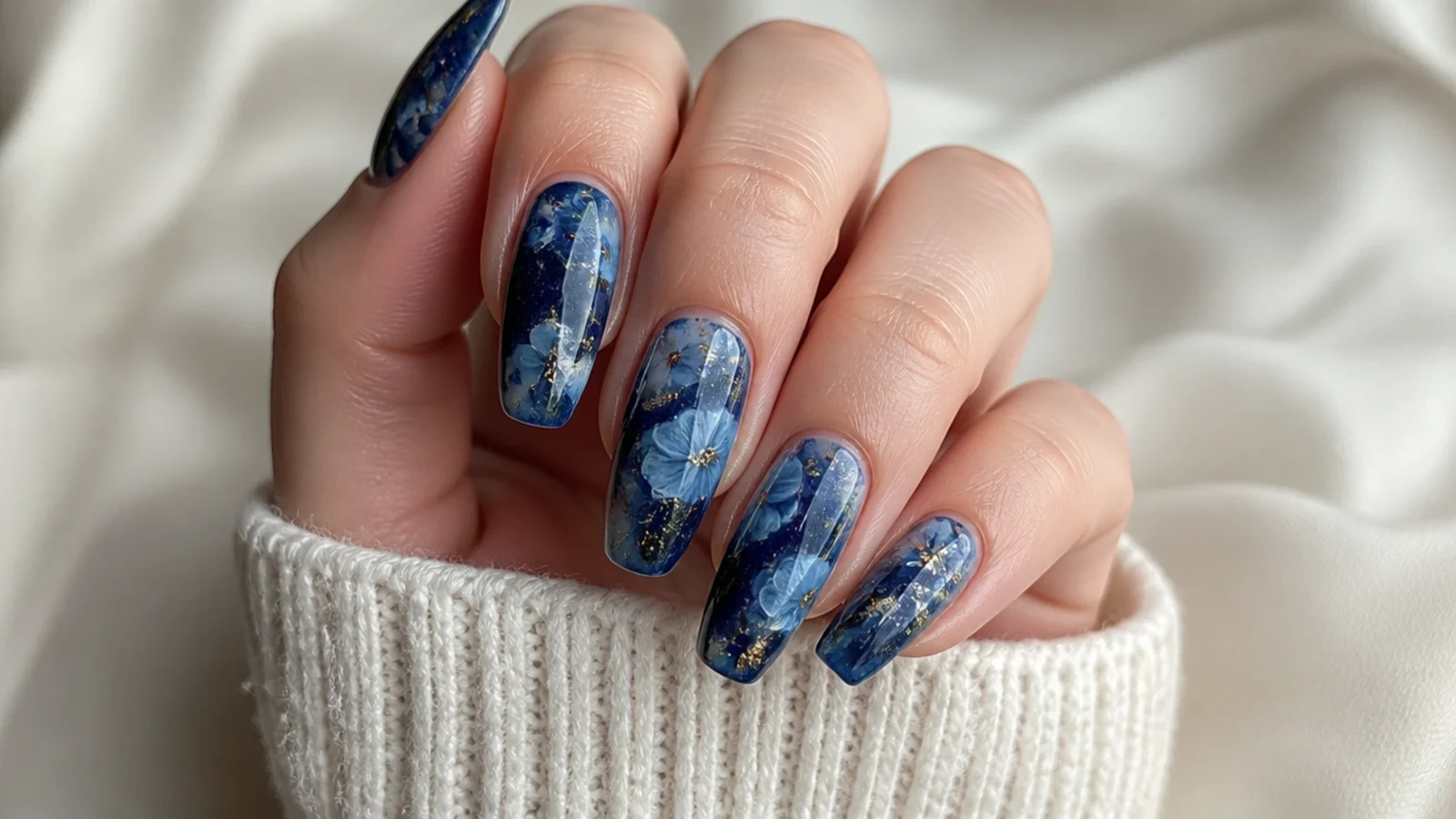 Blue blooming gel nails with deep midnight blue galaxy diffusion