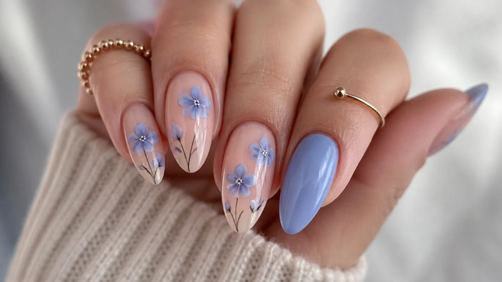 Blue blooming gel nails with soft periwinkle blue petal flowers