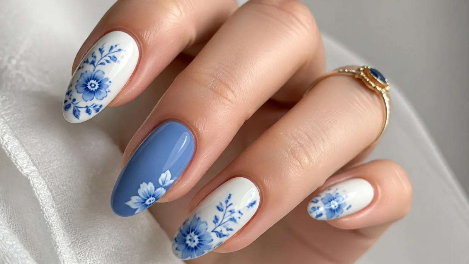 Blue blooming gel nails with blue-and-white porcelain ink detailing