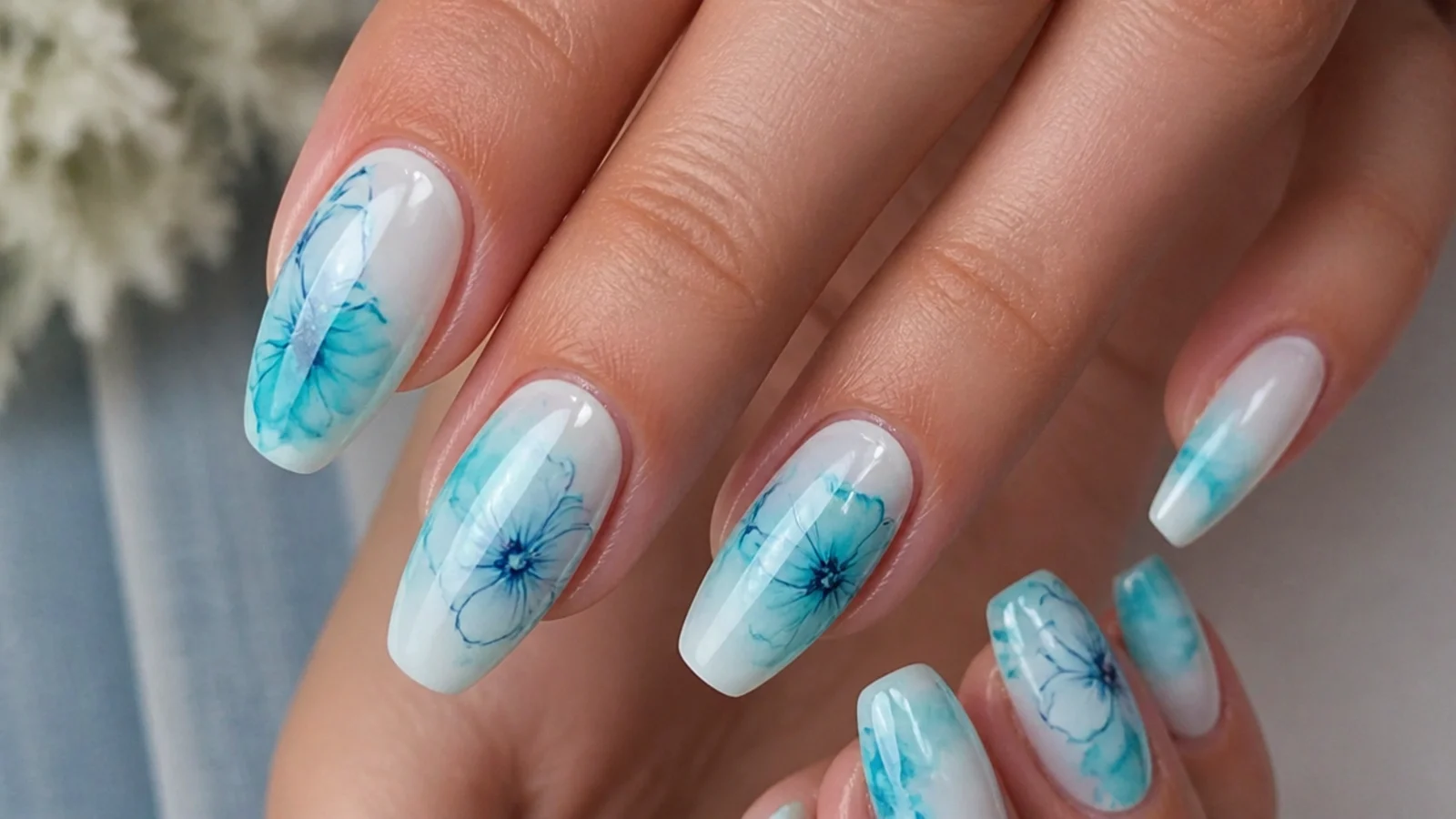 Blue blooming gel nails with a bright turquoise watercolor fade