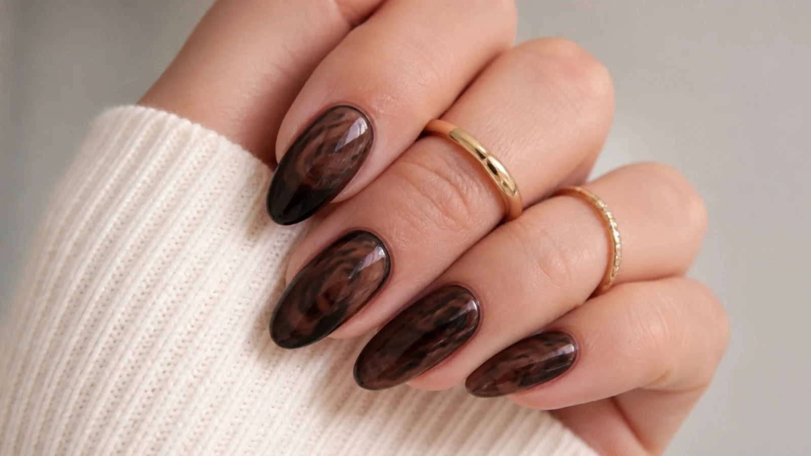 Deep dark chocolate blooming gel nails with subtle lighter blooming veins