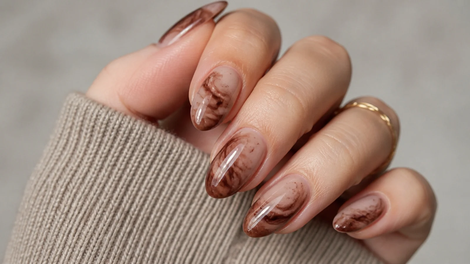 Short almond brown blooming gel nails with a soft mocha marble