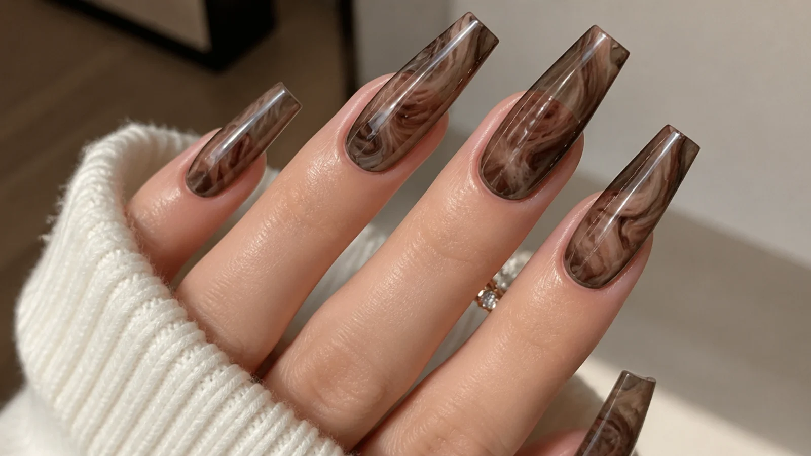 Long coffin brown blooming gel nails with a dramatic cocoa swirl marble