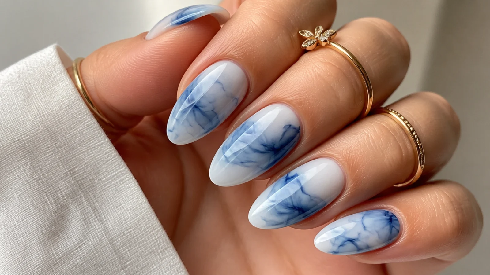 Blooming gel nails with blue and white ink-like tie-dye diffusion