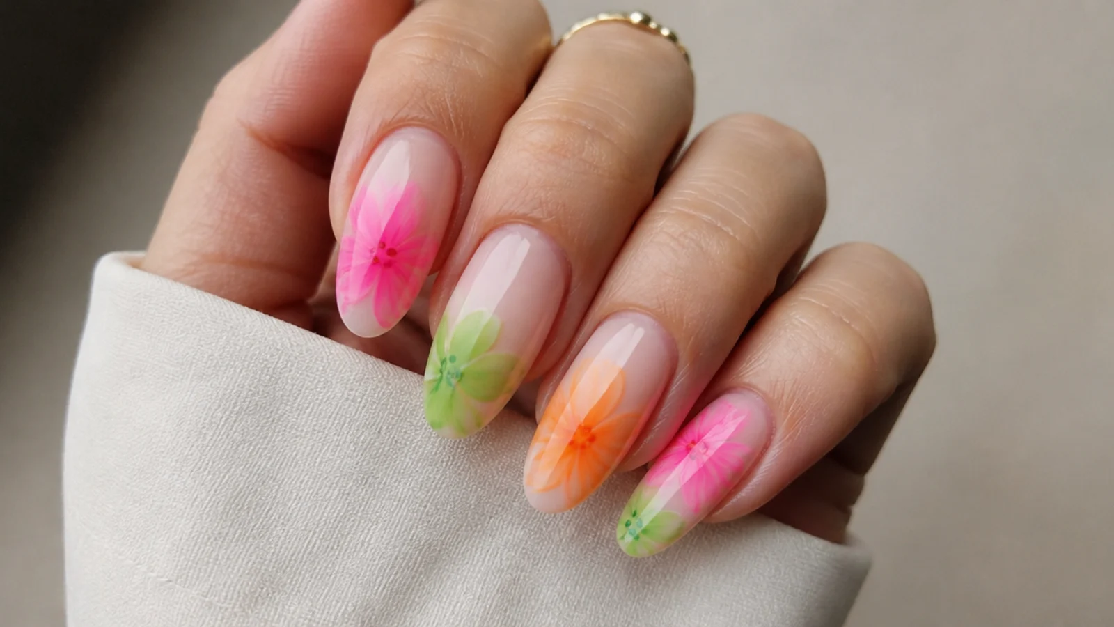 Blooming gel nails with soft-edged neon pink, green and orange blooms