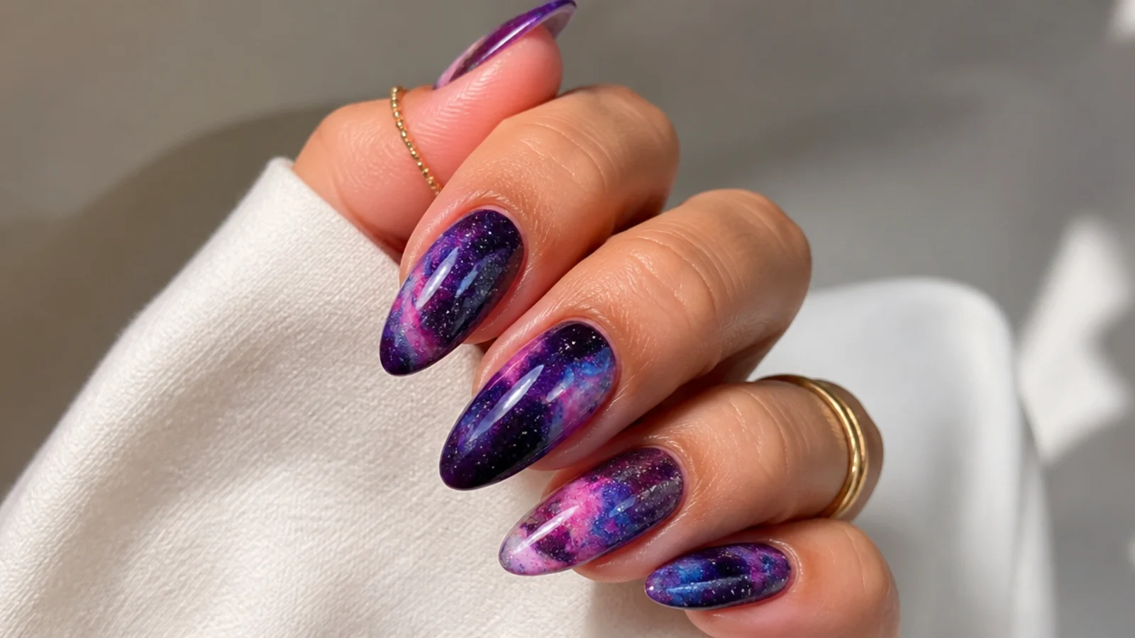 Blooming gel nails with deep purple, blue and magenta galaxy diffusion