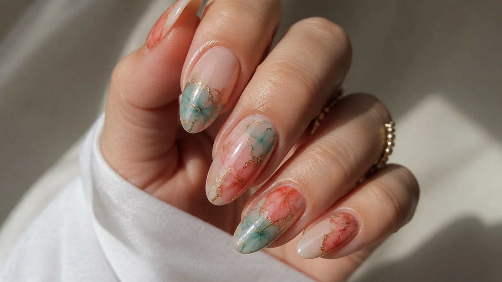 Blooming gel nails with coral and teal color diffusing together