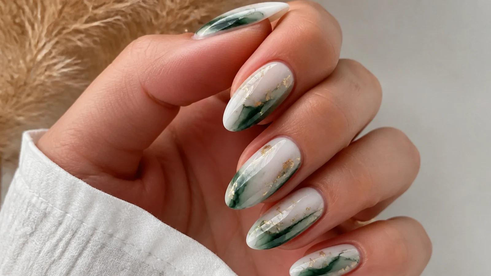 Blooming gel nails with emerald green bloom and gold flake accents