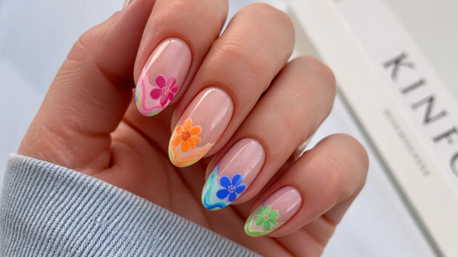 Blooming gel nails with bright multicolor swirls at the tips